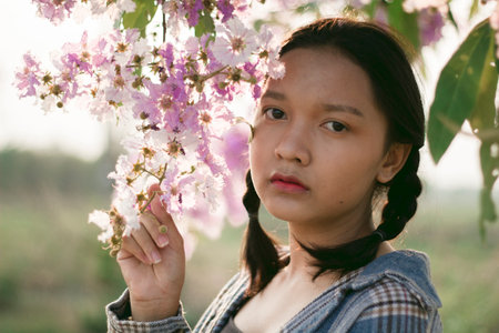 Portrait Asian girl with beautiful purple flower.の写真素材