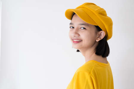 Young Asian girl wear yellow hat and T-Shirt on white background.の写真素材