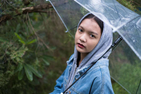 Young girl playing rainy at park.の写真素材