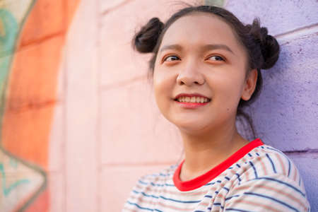 Asian young girl with colorful wall, Happy girl.の写真素材