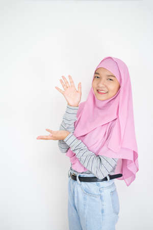 Beautiful young girl wear pink hijab on white background.の写真素材