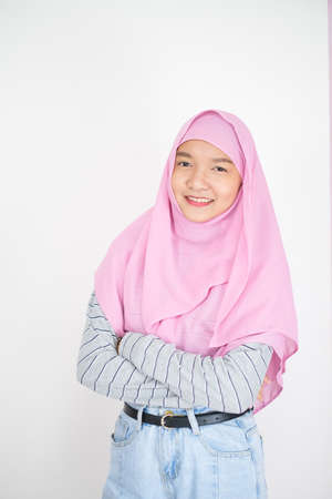Beautiful young girl wear pink hijab on white background.の写真素材