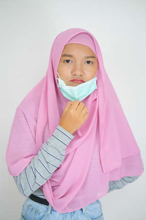 Young girl wear pink hijab on white background.の写真素材