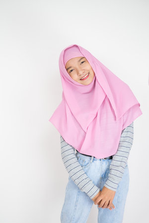 Beautiful young girl wear pink hijab on white background.の写真素材