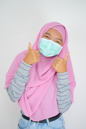 Young girl wear pink hijab on white background.の写真素材
