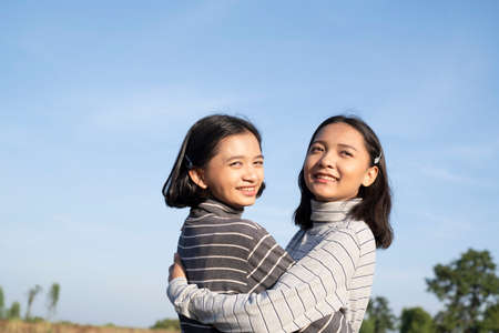 Two young girl with blue sky, Happy young girl.の写真素材