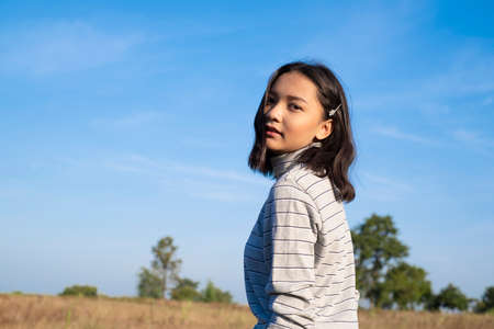 Beautiful young girl with blue sky.Asian girl.の写真素材