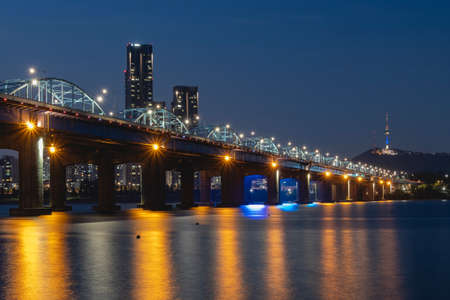 Seoul City skyline at Dongjak Bridge and Han river with beautiful light in Seoul, South Korea.の写真素材