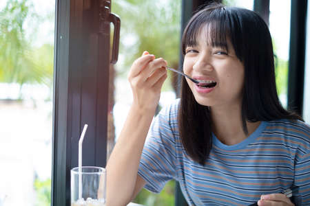A girl is having a delicious meal at a restaurant.の写真素材