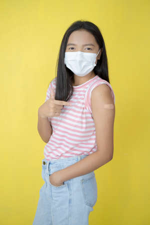 Beautiful young girl vaccination ,wear mask.の写真素材
