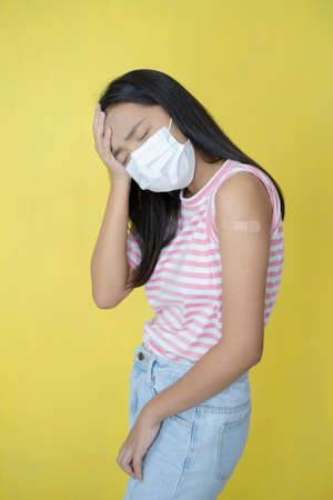 Beautiful young girl vaccination ,wear mask.の写真素材