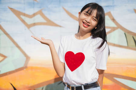 Portrait happy young girl on colorful background.の写真素材