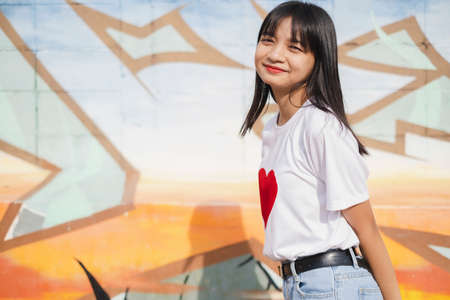 Portrait happy young girl on colorful background.の写真素材