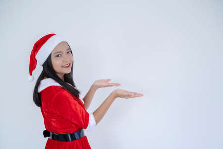 Happy Santa Claus girl on White background.の写真素材