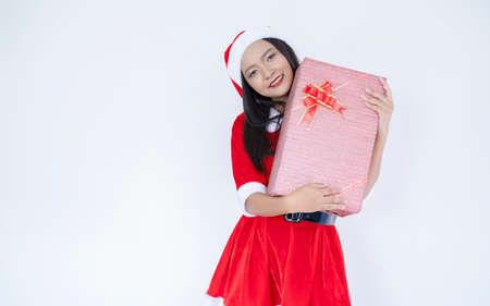 Happy Santa Claus girl with present box.White background.の写真素材