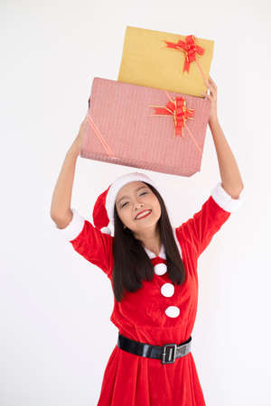 Happy Santa claus girl wear boot hold present box on white background.の写真素材