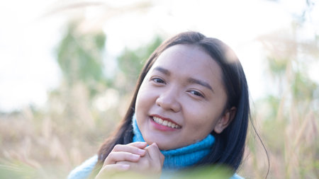 Happy young girl at the meadow with beautiful light before sunset time.の写真素材