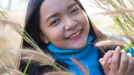 Happy young girl at the meadow with beautiful light before sunset time.の写真素材