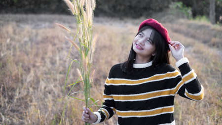 Happy young girl at the meadow with beautiful light before sunset time.の写真素材