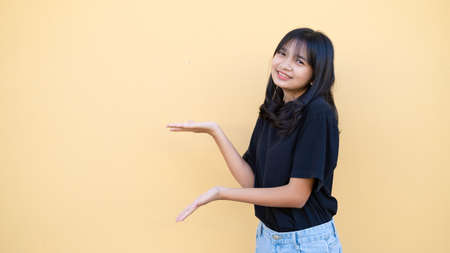 Portrait young girl with copy space on orange background.の写真素材