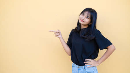 Portrait young girl with copy space on orange background.の写真素材