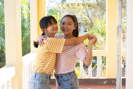 Two happy young girl playing together at school.の写真素材