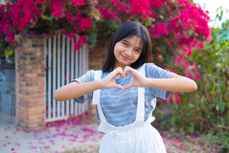 Portrait Young Asian girl outdoor, beautiful flower background.の写真素材