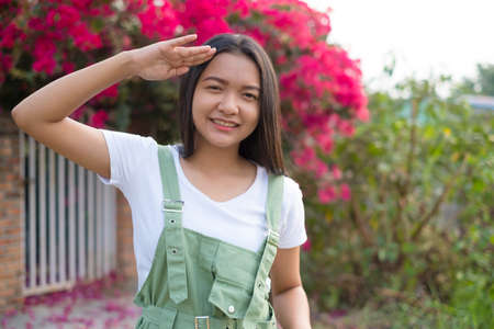 Portrait Young Asian girl outdoor, beautiful flower background.の写真素材