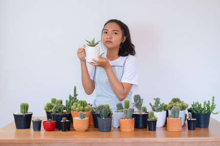 Happy smiling girl with cactus.の写真素材