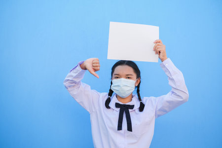 School girl show billboard on blue background.の写真素材