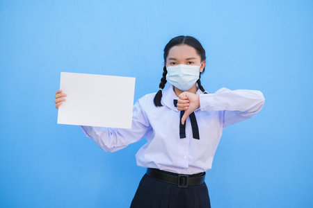 School girl show billboard on blue background.の写真素材