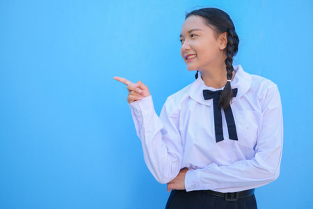 School girl on blue background.の写真素材