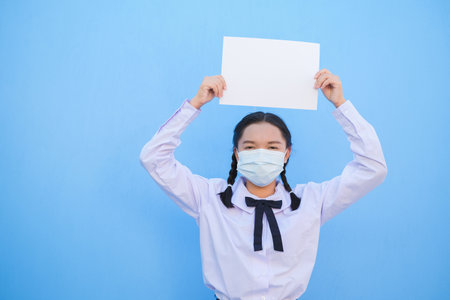 School girl show billboard on blue background.の写真素材