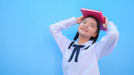 Happy school with book on blue background.の写真素材
