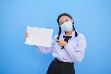 School girl show billboard on blue background.の写真素材