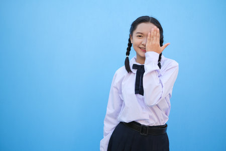 School girl on blue background.の写真素材