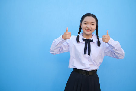 School girl on blue background.の写真素材
