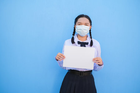 School girl show billboard on blue background.の写真素材
