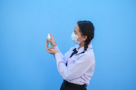 School girl wear mask on blue background,Back to school.の写真素材