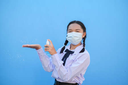 School girl wear mask on blue background,Back to school.の写真素材