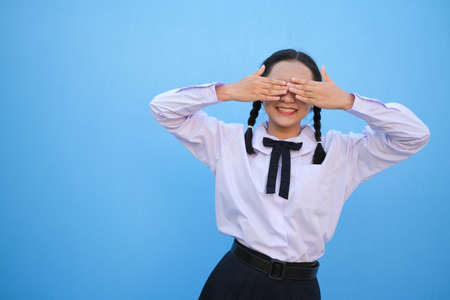 School girl on blue background.の写真素材