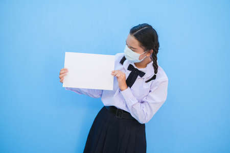 School girl show billboard on blue background.の写真素材