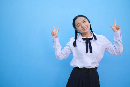 School girl on blue background.の写真素材