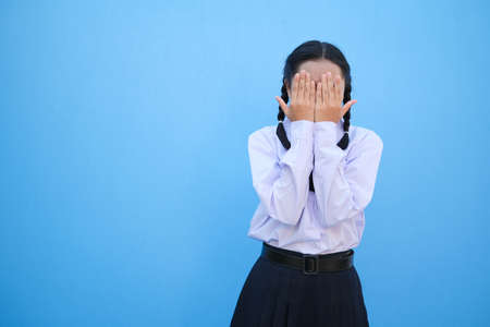 School girl on blue background.の写真素材
