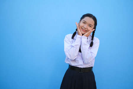 School girl on blue background.の写真素材