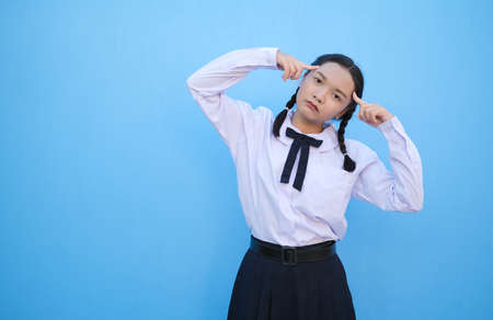 School girl on blue background.の写真素材