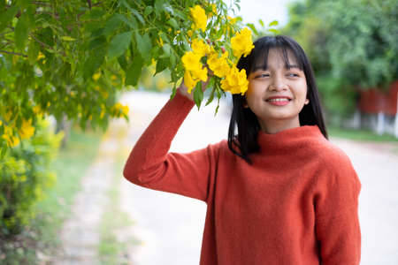 Portrait young girl with yellow flowers, Asian girl.の写真素材