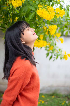 Portrait young girl with yellow flowers, Asian girl.の写真素材