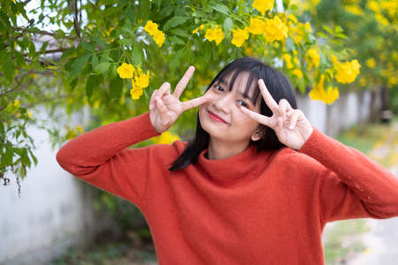 Portrait young girl with yellow flowers, Asian girl.の写真素材
