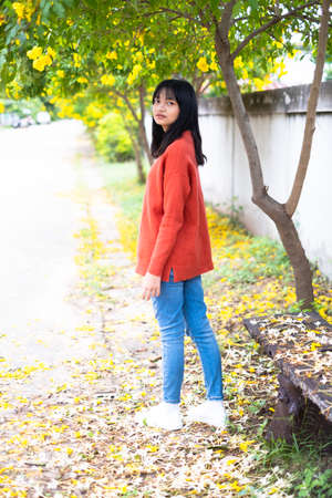 Happy young girl under the beautiful tree.の写真素材